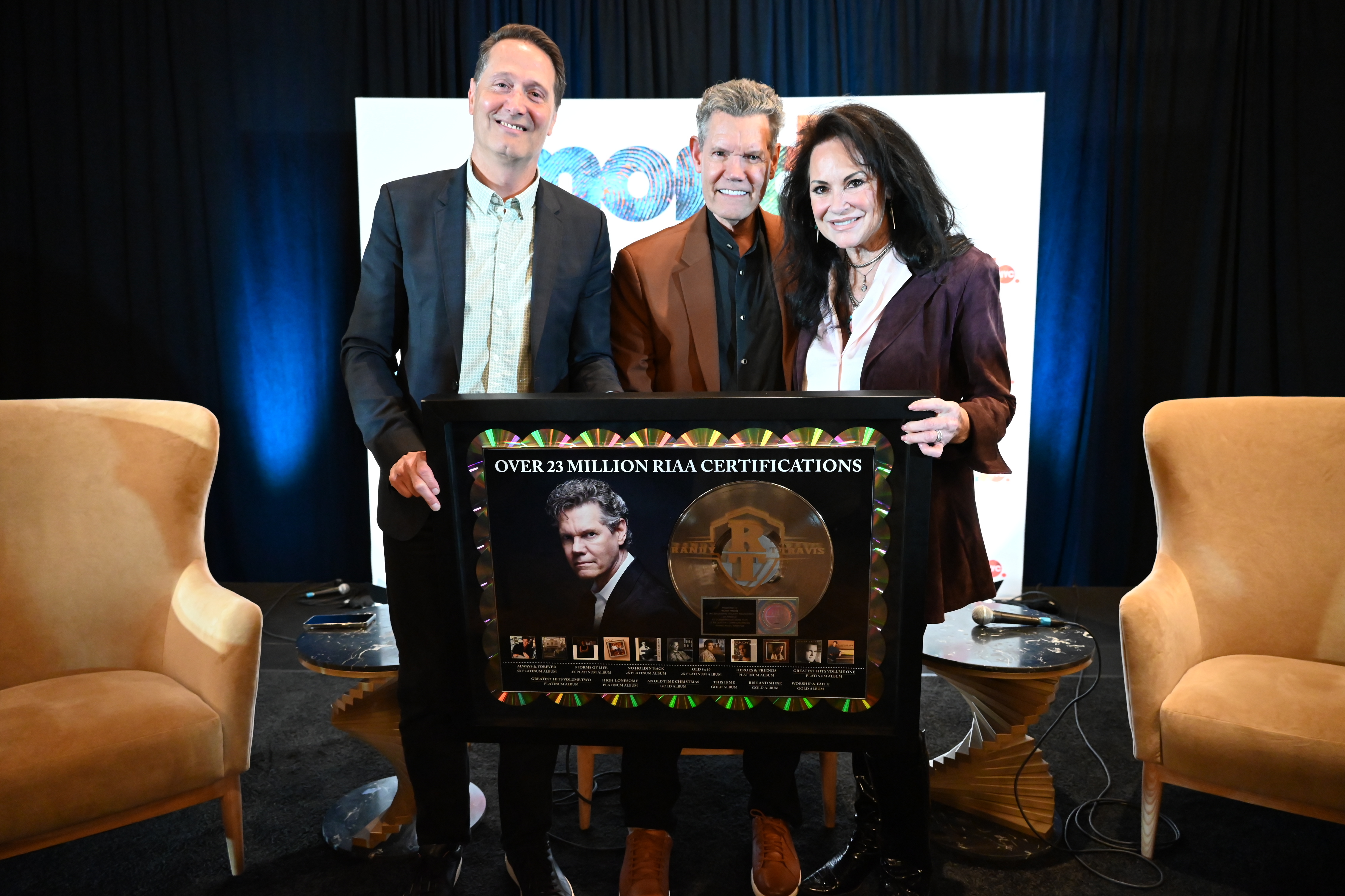 RANDY TRAVIS RECEIVES CAREER PLAQUE COMMEMORATING 23 MILLION CERTIFIED UNITS FROM RIAA CHAIRMAN & CEO MITCH GLAZIER AT MONDO.NYC